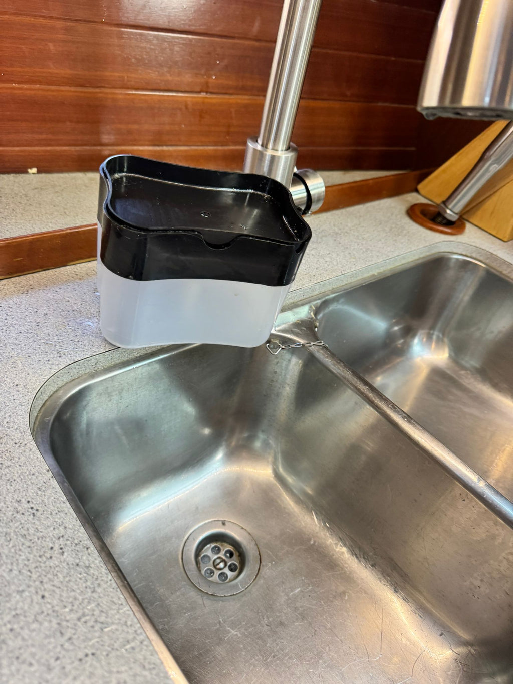 Soap dispenser holder preventing tipping during waves