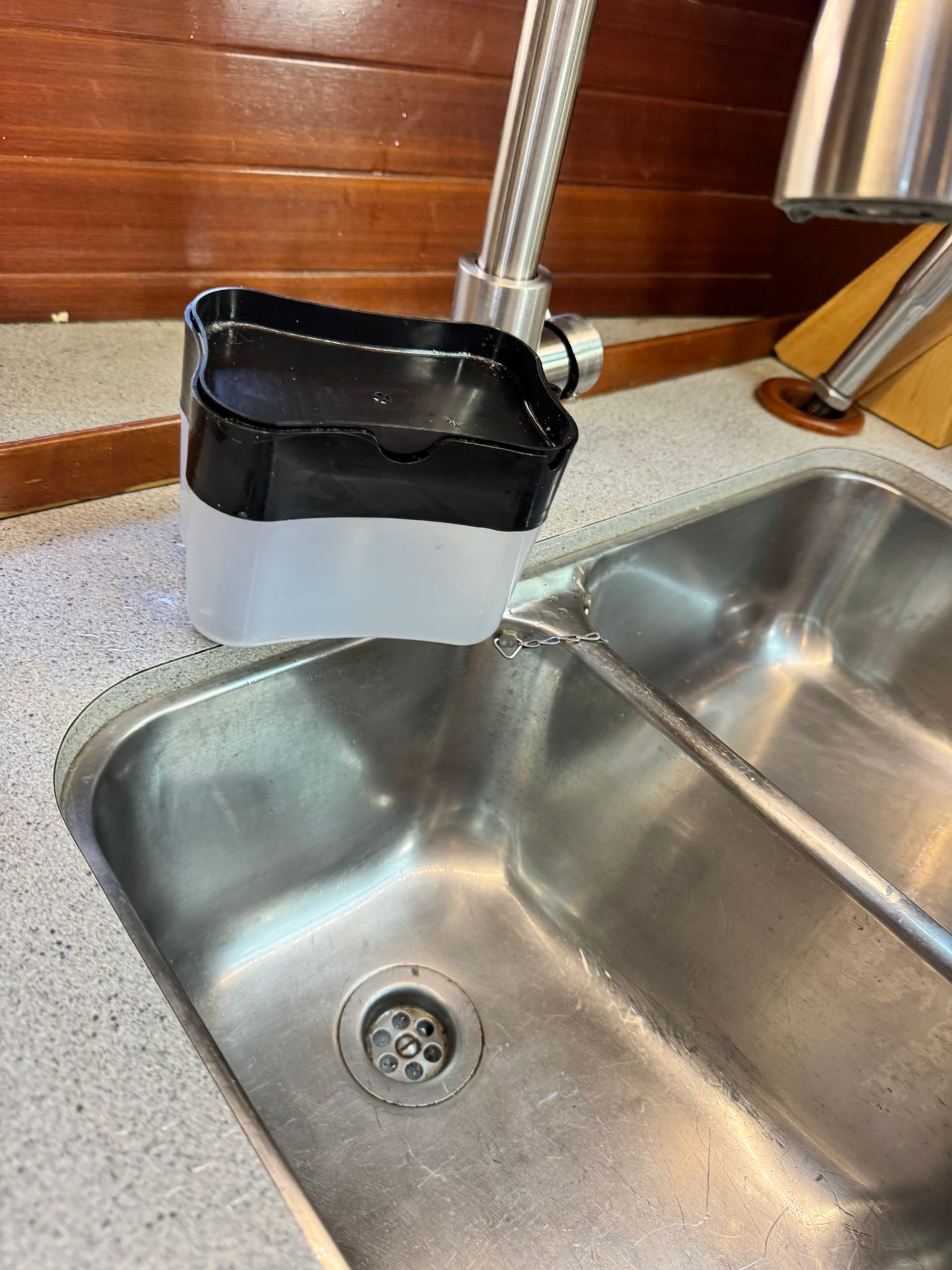 Soap dispenser holder preventing tipping during waves